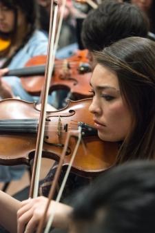A music department student playing the violin