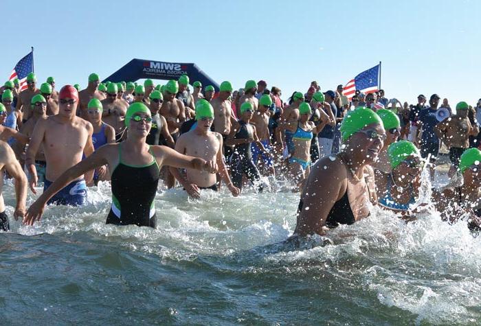 Swimmers running into the water 
